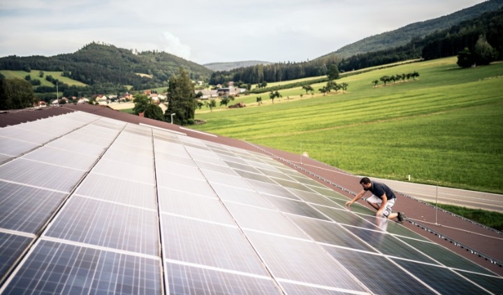 Mann arbeitet an Photovoltaikanlage